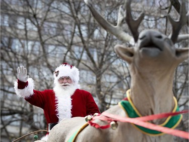 Santa waves to the crowd during the annual Santa Claus parade in Montreal on Saturday, Nov. 23, 2019.