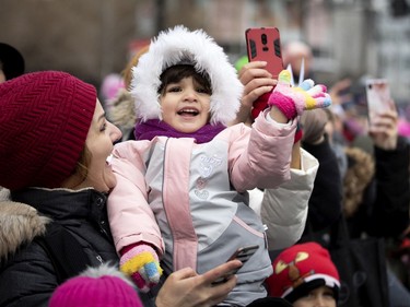 Nina reacts to seeing Santa Claus being pulled by huge reindeer during the annual Santa Claus parade in Montreal on Saturday, Nov. 23, 2019.