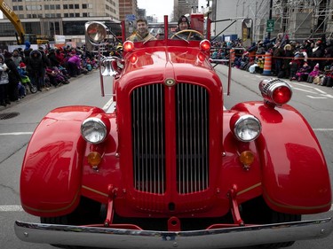 A vintage fire truck from the former city of Lachine takes part in the annual Santa Claus parade in Montreal on Saturday, Nov. 23, 2019.