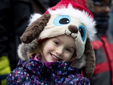 Kimberly Hubert, 6, smiles as she watches the annual Santa Claus parade in Montreal on Saturday, Nov. 23, 2019.