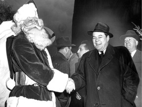 Santa shakes hands with John David Eaton, president of the family-run business, in November 1950, at what was then called the Eaton's Santa Claus Parade.