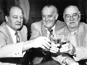 Toe Blake's Tavern regulars Jack Black (left), Vic Magwood and Pat Quinn lift their glasses in November 1983, as the closure of the tavern was imminent.