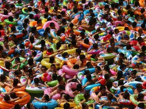 People cool off in a waterpark in Suining, southwest China's Sichuan province, during a summer heat wave.