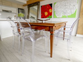 Traditional dining table with modern "ghost" chairs at Susan and Keith Porter's Griffintown apartment.