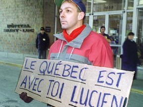 Carl Pearson stands outside St. Luc Hospital holding a sign of support for Lucien Bouchard, who inside was in intensive care, battling necrotizing myositis. This photo was published on Page 1 of the Montreal Gazette on Dec. 3, 1994.