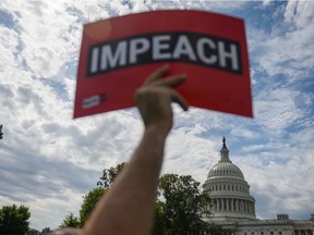 A protester holds up a sign outside the U.S. Capitol building during a recent anti-Trump rally in Washington.