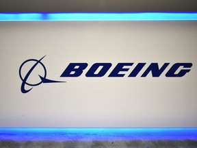 In this file photo taken on Oct. 22, 2019, the Boeing logo is seen during the the 70th annual International Astronautical Congress at the Walter E. Washington Convention Center in Washington, D.C.