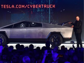 Tesla co-founder and CEO Elon Musk gestures while wrapping up his presentation of the newly unveiled all-electric battery-powered Tesla Cybertruck at Tesla Design Center in Hawthorne, California on November 21, 2019.
