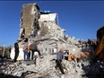 Emergency workers clear debris at a damaged building in Thumane, 34 kilometres (about 20 miles) northwest of capital Tirana, after an earthquake hit Albania, on Nov. 26, 2019. (GENT SHKULLAKU/AFP via Getty Images)