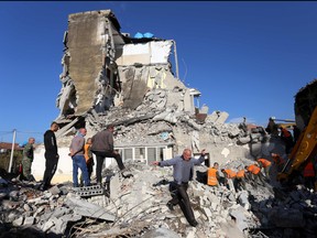 Emergency workers clear debris at a damaged building in Thumane, 34 kilometres (about 20 miles) northwest of capital Tirana, after an earthquake hit Albania, on Nov. 26, 2019. (GENT SHKULLAKU/AFP via Getty Images)