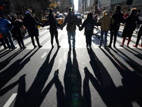 Protesters with Extinction Rebellion NYC, Extinction Rebellion Youth NYC, and NYC Youth gather for a protest outside the New York Public Library on Friday, Nov. 29, 2019, in New York City as part of a strike on Black Friday to demand transformative climate action. A number of members of the group were arrested for blocking traffic