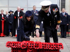 Britain's Prince Harry and Meghan, Duchess of Sussex place a cross during the 91st Field of Remembrance at Westminster Abbey in London, Britain November 7, 2019.  Kirsty Wigglesworth/Pool via REUTERS