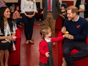 Poppy Dean gives a cake to Britain's Prince Harry during a coffee morning with families of deployed Army personnel at Broom Farm Community Centre in Windsor, Britain November 6, 2019. Picture taken November 6, 2019. Sgt Paul Randall/MoD/Handout via REUTERS  THIS IMAGE HAS BEEN SUPPLIED BY A THIRD PARTY.