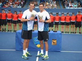 Mike Bryan, left, and Bob Bryan pose for the trophy ceremony after the final doubles match against Vasek Pospisil and Jack Sock on day 9 of the Western & Southern Open at the Linder Family Tennis Center on Aug. 17, 2014 in Cincinnati, Ohio.