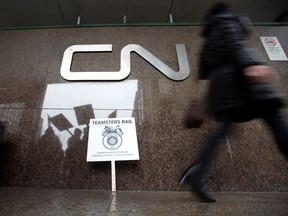 Teamsters Canada union workers are reflected as they picket outside the headquarters of Canadian National Railway (CN Rail) after both parties failed to resolve contract issues, in Montreal, Quebec, Canada November 19, 2019.