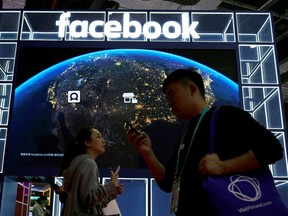 A Facebook sign is seen at the second China International Import Expo in Shanghai. Our social media feeds are increasingly flooded with fake or misleading material, writes Matthew Johnson of MediaSmarts.
