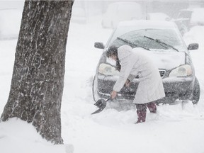 Villeray resident Jun shovels a parking space during a heavy snowstorm in Montreal in 2012.