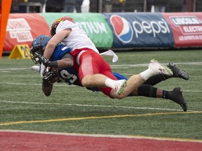 University of Calgary Dinos' Grant McDonald, top, tackles University of Montreal Carabins' Ryth-Jean Giraud during first half U Sports Vanier Cup university football action in Quebec City, on Saturday, Nov. 23, 2019.