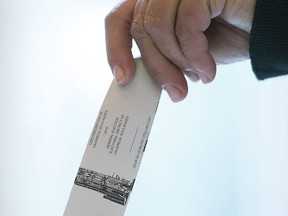 A woman casts her ballot in the riding of Vaudreuil—Soulanges, west of Montreal, on election day on Oct. 19, 2015. Courts in Quebec and British Columbia have ordered recounts in two ridings where the runners-up are hoping a review could snatch victories from the jaws of every-so-narrow losses.