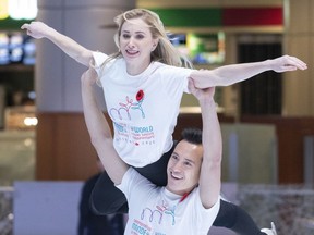 Canadian figure skater Patrick Chan lifts compatriot Joannie Rochette as they are introduced as athlete ambassadors for the ISU 2020 World Figure Skating Championships in Montreal on Monday, Nov. 4, 2019.