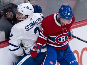 Toronto Maple Leafs' Jordan Schmaltz is rammed into the boards by Montreal Canadiens' Riley Barber while reaching for the puck during pre-season game in Montreal on Sept. 23, 2019.