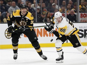 Boston Bruins defenceman Zdeno Chara and Pittsburgh Penguins centre Jake Guentzel pursue puck during the second period at TD Garden in Boston on Nov. 4, 2019.