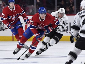 Canadiens forward Nick Suzuki  plays the puck as Los Angeles Kings forward Blake Lizotte  defends at the Bell Centre in Montreal on Saturday, Nov. 9, 2019.