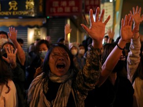 Protesters raise their hands outside the Polytechnic University (PolyU) in Hong Kong, China, November 25, 2019.