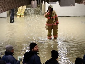 A firefighter walks through flooded Square Victoria métro station Nov. 14, 2019.