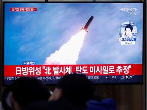 People watch a TV broadcasting file footage for a news report on North Korea firing an unidentified projectile, in Seoul, South Korea, November 28, 2019.