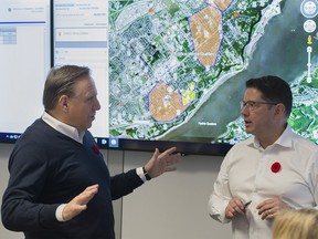 Quebec Premier François Legault, left, and Hydro Quebec President and CEO Eric Martel attend a briefing in Montreal, Saturday, November 2, 2019, where they updated news media on the ongoing power outages in the province.THE CANADIAN PRESS/Graham Hughes ORG XMIT: GMH103