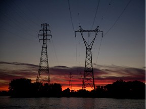The sun sets behind Hydro-Québec transport towers.