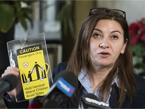 Bela Kosoian holds up a sign during a news conference in Montreal on Friday, Nov. 29, 2019.