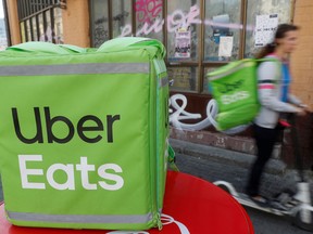 An Uber Eats food delivery courier rides a scooter in central Kiev, Ukraine.