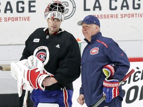 Carey Price has a conversation with coach Claude Julien during Montreal Canadiens practice at the Bell Sports Complex in Brossard on Jan. 31, 2019.