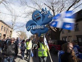 A group at a Bill 21 demonstration chant as they walk outside TVA offices in Montreal, Quebec May 4, 2019.