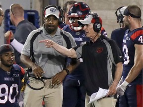 Montreal Alouettes head coach Khari Jones, left, has a conversation with defensive coordinator Bob Slowik  during Canadian Football League game against the  Hamilton Tiger-Cats in Montreal Thursday July 4, 2019. (John Mahoney / MONTREAL GAZETTE) ORG XMIT: 62784 - 3469