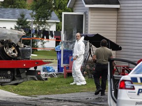 Police investigate at the scene of a fire in Gatineau's Buckingham district on Saturday, August 31, 2019.