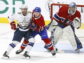 Canadiens defenceman Otto Leskinen battles with Quebec university all-star team’s Ryan Penny in front of goalie Alexis Shank during exhibition game at the Bell Sports Complex in Brossard on Sept. 10, 2019.