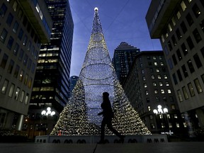 A woman walks past the Christmas tree in Place Ville Marie in Montreal Wednesday November 8, 2017.