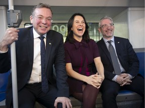 Montreal Mayor Valérie Plante is flanked by STM chairman Philippe Schnobb, left, and STM director general Luc Tremblay inside a new hybrid bus on Thursday, Nov. 21, 2019.