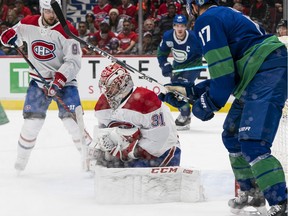 Canadiens goalie Carey Price makes a save while the Canucks' Josh Leivo looks for a rebound during NHL game at Rogers Arena in Vancouver on Dec. 17, 2019.