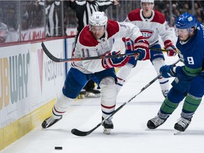 The Canadiens’ Brendan Gallagher chases down a loose puck after getting paste Canucks' J.T. Miller during NHL game at Rogers Arena in Vancouver on Dec. 17, 2019