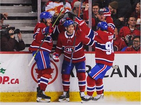 Canadiens' Max Domi, centre, celebrates after scoring in overtime against the Calgary Flames at the Scotiabank Saddledome on Dec. 19, 2019, in Calgary.