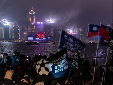 Pro-democracy supporters wave flags and shout slogans during a countdown party in Tsim Sha Tsui district on New Year's eve on January 1, 2020 in Hong Kong, China. Anti-government protesters in Hong Kong continue their demands for an independent inquiry into police brutality, the retraction of the word "riot" to describe the rallies, and genuine universal suffrage.
