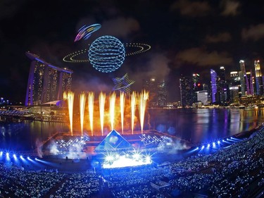 Drones are seen in the sky forming the shape of a planet as Singapore awaits 2020 with curtain-raiser fireworks by Star Island as revellers join in the biggest countdown celebration at Marina Bay on December 31, 2019 in Singapore.