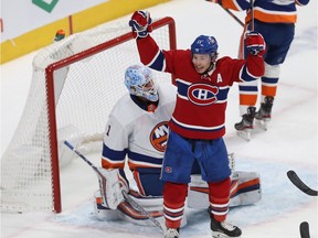 Brendan Gallagher (11) celebrates goal by Montreal Canadiens' Phillip Danault (24) on New York Islanders goaltender Thomas Greiss during first period NHL action in Montreal on Tuesday December 03, 2019.