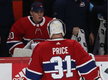 Montreal Canadiens goaltender Cayden Primeau looks at Carey Price while sitting on the bench during second period NHL action in Montreal on Tuesday December 03, 2019.