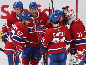 Canadiens players congratulate goalie Carey Price after 4-2 win over the New York Islanders in NHL game at the Bell Centre in Montreal on Dec. 3, 2019.