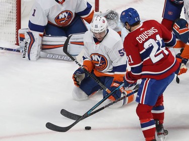 Montreal's Nick Cousins (21) looks for shot on New York Islanders goaltender Thomas Greiss, while defenseman Johnny Boychuk (55) comes in on play, during first period NHL action in Montreal on Tuesday December 03, 2019.